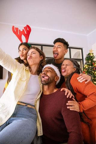 Diverse Friends Celebrating Holiday with Playful Group Selfie