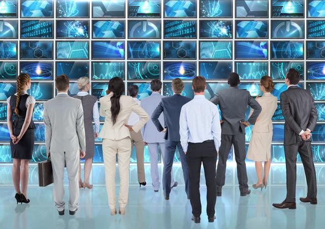 Group of business executives standing and analyzing multiple digital screens displaying complex data and digital interfaces. Ideal for illustrating concepts of teamwork, corporate strategy, digital transformation, and technological innovation in business settings. Suitable for use in business presentations, corporate websites, and articles on technology and business strategy.