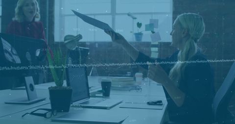 Businesswoman analyzing data at desk in modern office