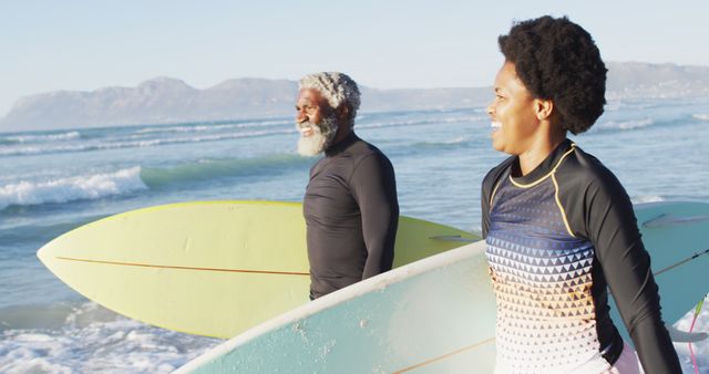 Happy Mature Couple Carrying Surfboards on Sunny Beach - Download Free Stock Images Pikwizard.com