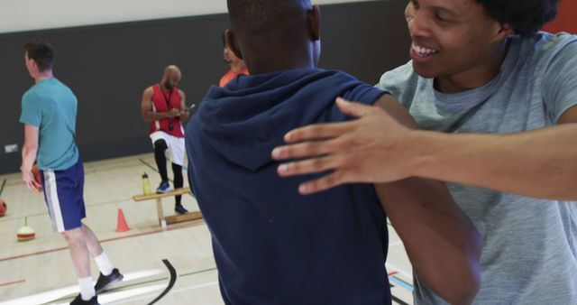 Two Friends Celebrating During Indoor Basketball Game - Download Free Stock Images Pikwizard.com