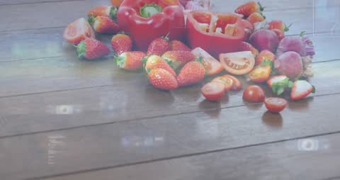 Light casting shifting rectangles across wood tabletop with strawberries and red pepper