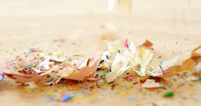 Colorful pencil shavings scattered on wooden surface - Download Free Stock Images Pikwizard.com