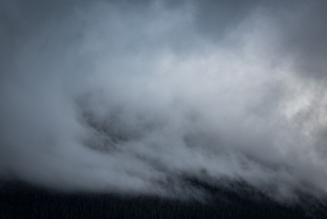 Misty Clouds Rolling Over Dark Mountain Forest - Download Free Stock Photos Pikwizard.com