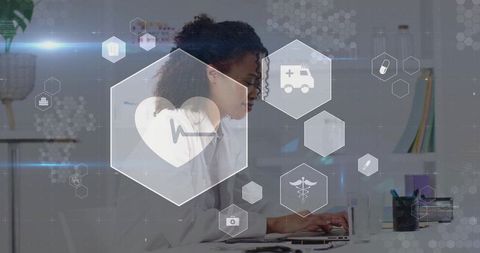 Female doctor using laptop with futuristic medical icons in modern office