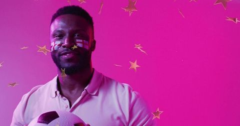 Vibrant Soccer Fan Holding Ball with Festive Face Paint