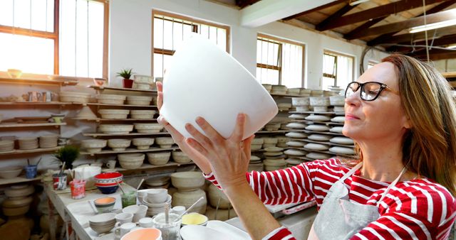 Woman Pottery Artist Examining Ceramic Bowl in Studio - Download Free Stock Images Pikwizard.com