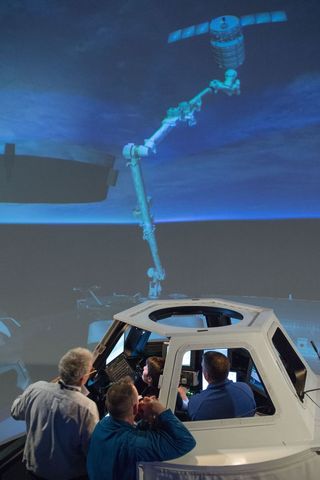 Nasa astronauts training with robotic arm simulator, october 2013
