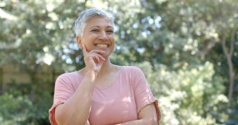 Joyful Senior Woman Relaxing in Outdoor Garden Setting