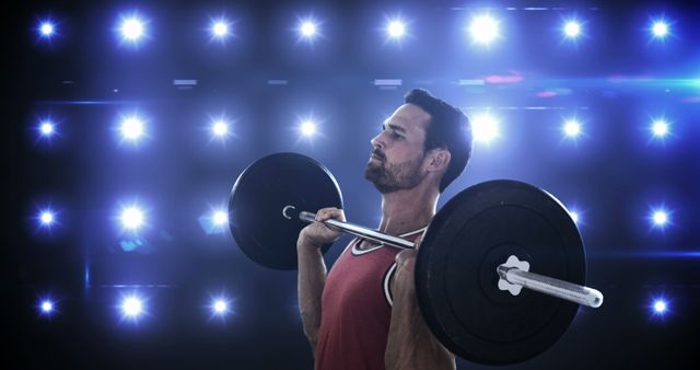 Dedicated Man Lifting Barbell in Gym with Intense Lighting - Download Free Stock Images Pikwizard.com