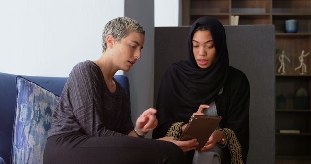 Businesswomen Collaborating on Project with Digital Tablet in Modern Office - Download Free Stock Images Pikwizard.com