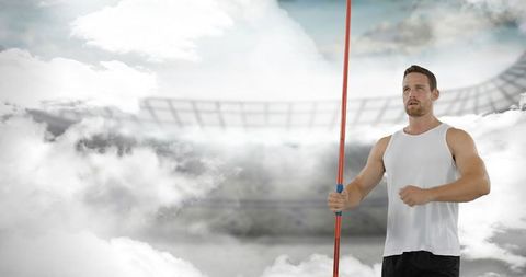 Athlete holding javelin in stadium, ready for competition
