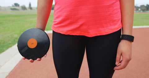 Female athlete prepares for discus throw in sports venue