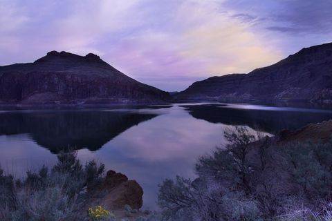 Lavender Twilight Reflecting Over Desert Canyon Lake With Mirror Calm Water