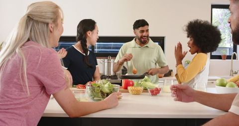 Diverse Friends Cooking Together at Modern Home Kitchen Island