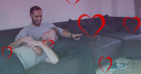 Diverse Male Couple Relaxing with Romantic Love Hearts