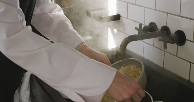 Chef Draining Freshly Cooked Pasta in Steamy Kitchen Setting - Download Free Stock Images Pikwizard.com