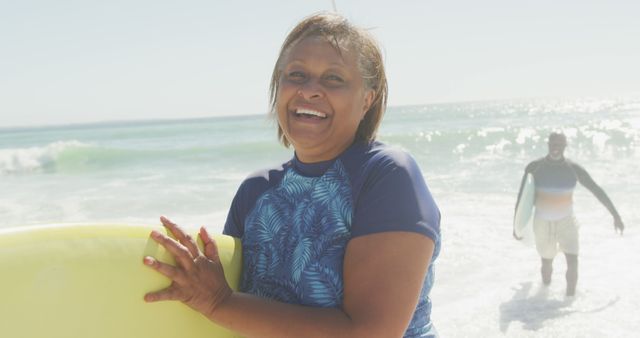 Smiling Middle-Aged Woman Holding Surfboard at Beach - Download Free Stock Images Pikwizard.com