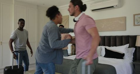 Friends Arriving at Hotel Room Excited for Celebration