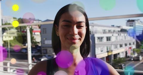 Glowing Lights over Biracial Woman Practicing Yoga Outdoors