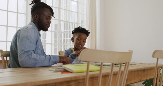 Father Helping Son with Homework at Dining Table - Download Free Stock Images Pikwizard.com