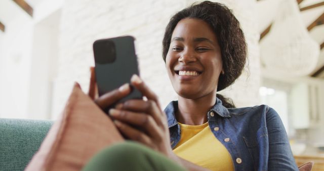 Smiling Woman Using Smartphone on Couch at Home - Download Free Stock Images Pikwizard.com