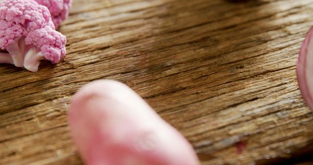 Close-Up of Fresh Pink Cauliflower on Rustic Wooden Table - Download Free Stock Images Pikwizard.com