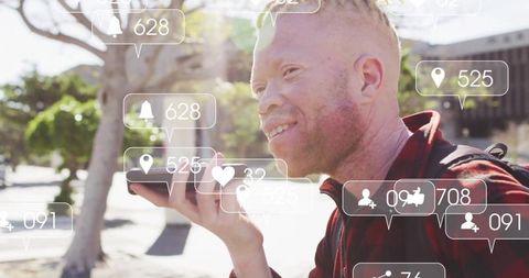 Man Holding Phone Interacting with Social Media Notifications Outdoors