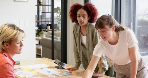 Diverse Female Coworkers Collaborating in Modern Office Meeting
