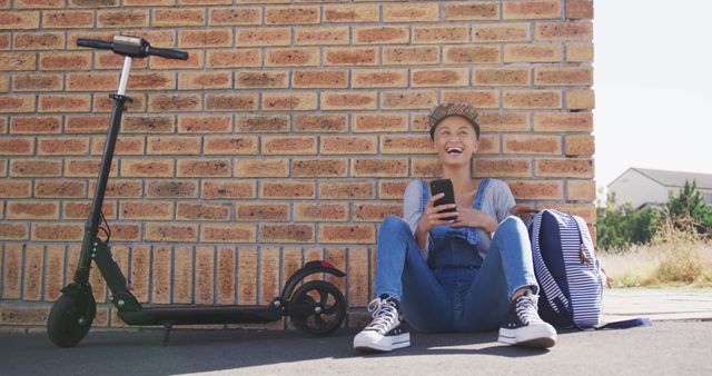 Smiling Teen Girl Sitting with Electric Scooter and Backpack Outdoor - Download Free Stock Images Pikwizard.com