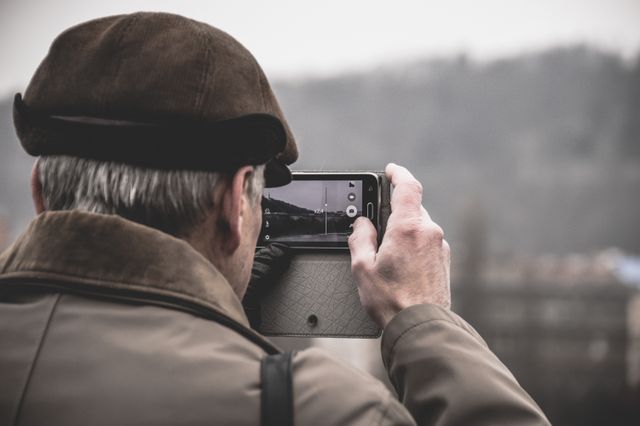 Senior Man Taking Photos with Mobile Phone Outdoors - Download Free Stock Photos Pikwizard.com