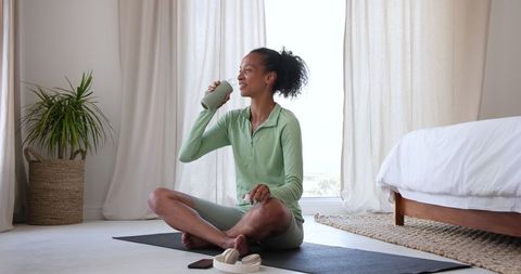Woman Practicing Mindfulness on Yoga Mat in Relaxed Home Environment