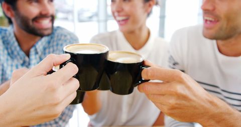 Friends enjoying coffee and laughter together