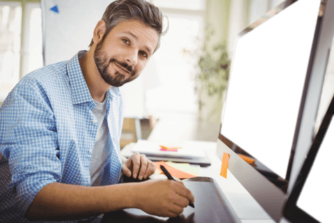smiling designer using graphics tablet at transparent monitor - Download Free Stock Videos Pikwizard.com