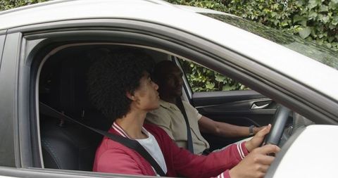 Teen and parent in car: safe driving instruction