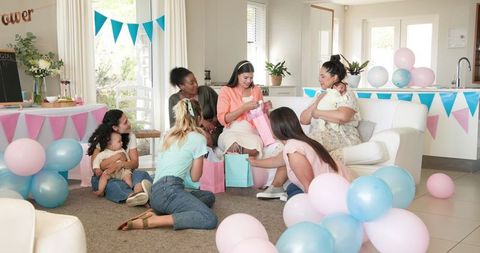 Diverse Friends Celebrating Baby Shower with Gifts and Joyful Atmosphere