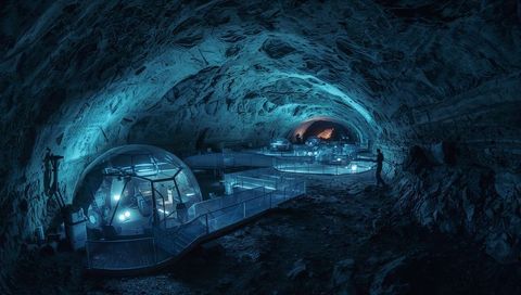 Glowing geodesic dome hosting futuristic subterranean research habitat with lit walkways