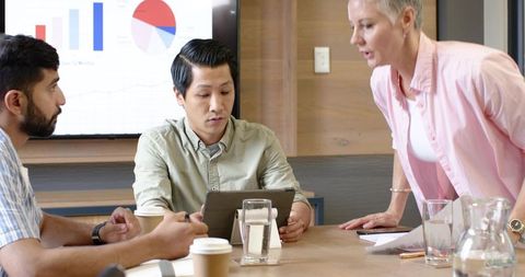 Diverse team collaborating on data analysis in modern meeting room