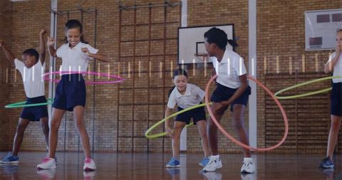 Primary students practicing hula hoop fitness during school gym class