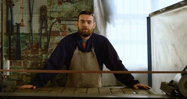 Bearded Craftsman in Apron Working in Industrial Workshop - Download Free Stock Images Pikwizard.com