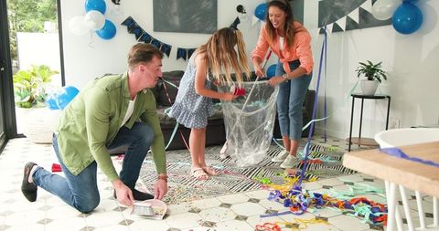 Happy Family Enjoying Post-Birthday Party Clean-up at Home