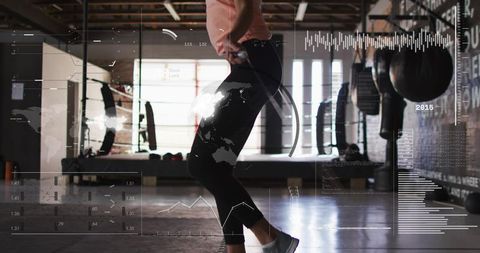 High-tech jump rope workout in boxing gym with hud fitness data overlays, performance data