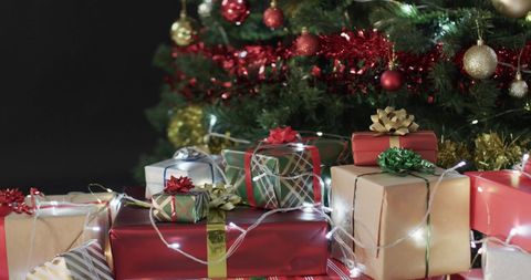 Holiday Gifts Under Decorated Christmas Tree with Lights and Ornaments - Download Free Stock Images Pikwizard.com