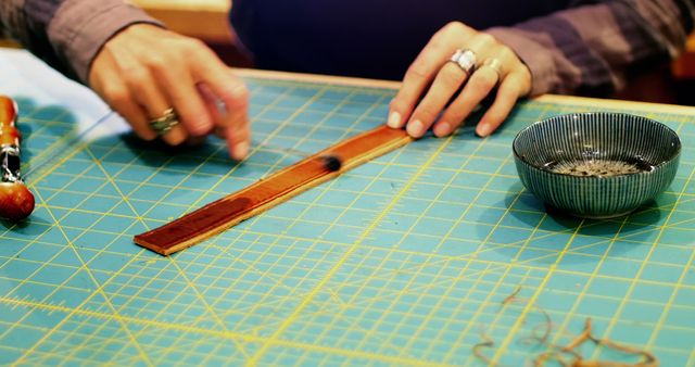 Artisan Crafting Leather Bracelet on Gridded Mat - Download Free Stock Images Pikwizard.com