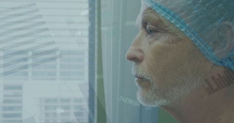 Senior surgeon analyzing data with thoughtful expression