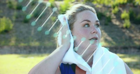 Caucasian Woman with Towel Over Shoulder Against DNA Strand Background