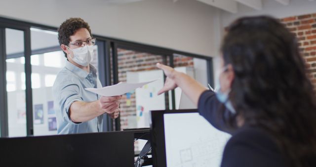 Office Workers Wearing Face Masks, Collaborating, Handing Documents - Download Free Stock Images Pikwizard.com