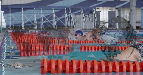 Male swimmer powering freestyle sprint in indoor pool with orange lane dividers