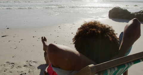 Relaxing on Beach with Cocktail Enjoying Ocean View