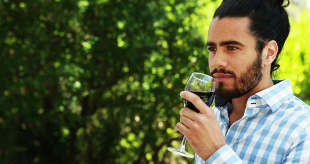 Man enjoying red wine outdoors in casual setting - Download Free Stock Images Pikwizard.com